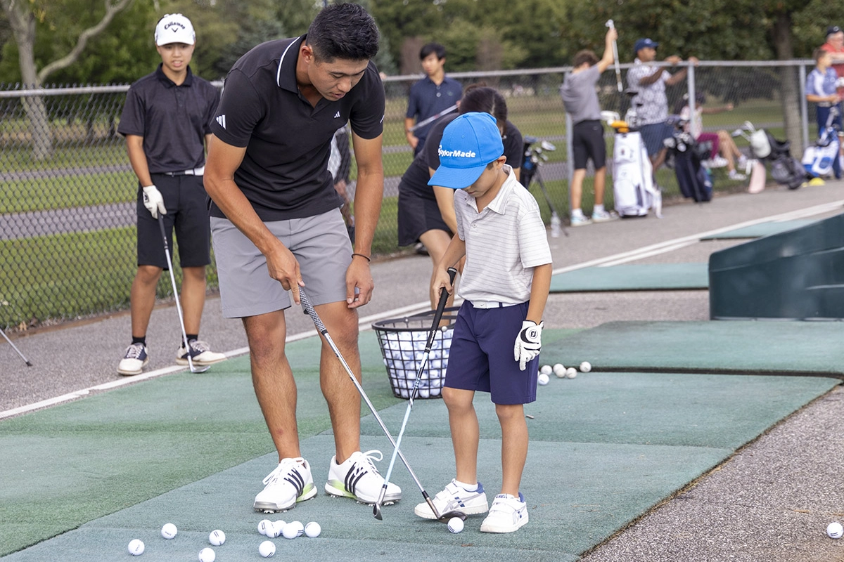 collin morikawa teaching a child golf