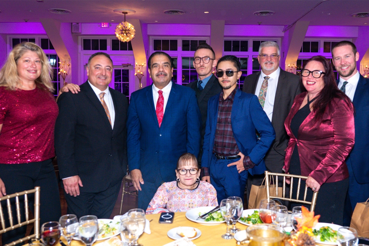 a group of people taking a photo at dinner