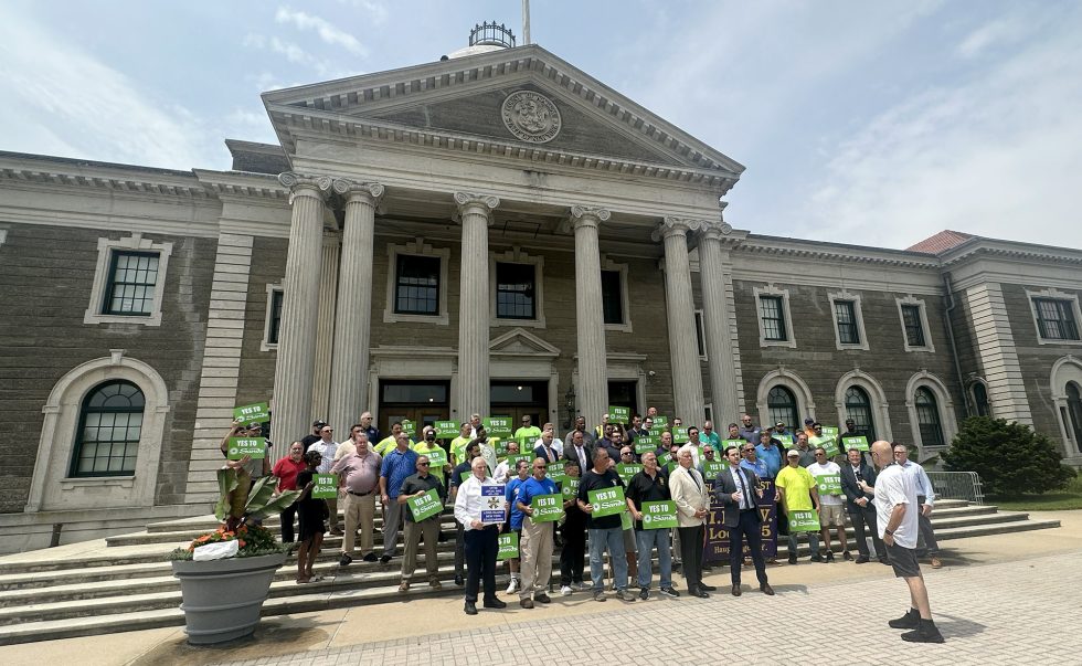 Group photo of organized labor members on the steps of the Nassau County Legislative Building.